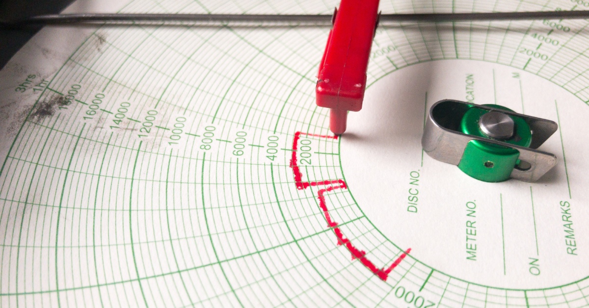 A close-up of an analog chart recorder observing pressure. The red pen makes markings at 2,000 psi and above after 2 hours.